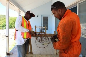 Workers for contractors of the new water taxi pier at Oualie Bay constructing steel casings for the project on August 23, 2018