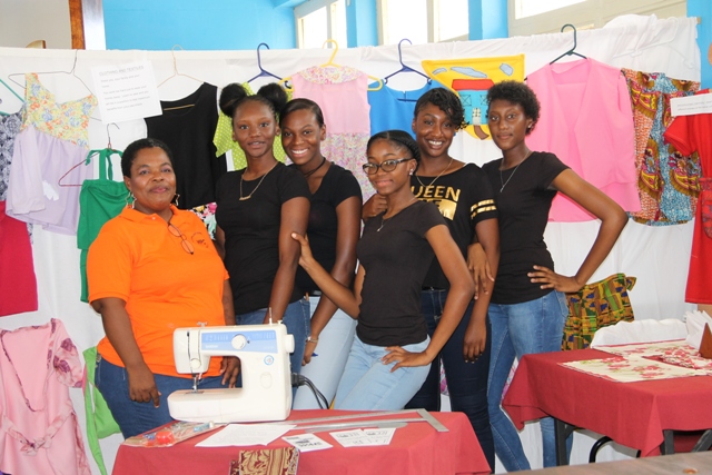 Ms. Mavis Parris (left) Clothing and Textiles teacher at the Charlestown Secondary School with some of her students at an exhibition (file photo)