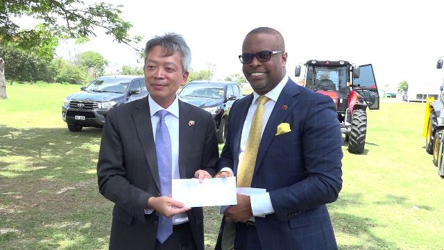 Republic of China (Taiwan) Resident Ambassador to St. Kitts and Nevis His Excellency Tom Lee, on behalf of his government and people, hands over a cheque and keys to Hon Mark Brantley, Premier of Nevis at Pinney’s Estate on August 28, 2018