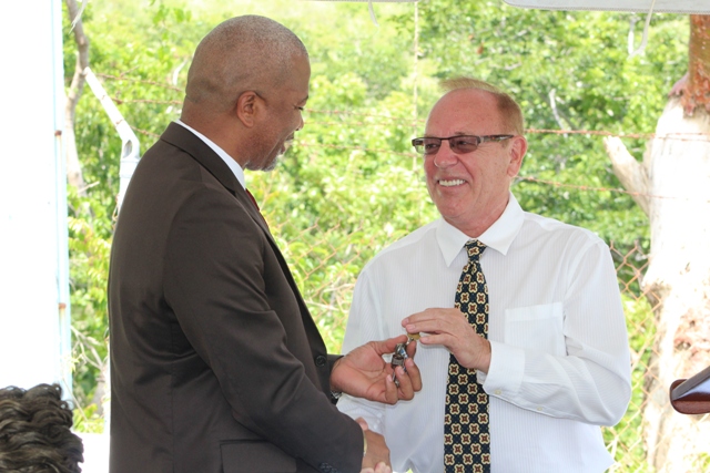 Hon. Spencer Brand, Minister of Water Services on Nevis receives keys for the pump station and wells at Maddens Estate from Mr. Michael Miville, Chief Executive Officer of Bedrock Exploration and Development Technologies LLC at a handing over ceremony on October 05, 2018