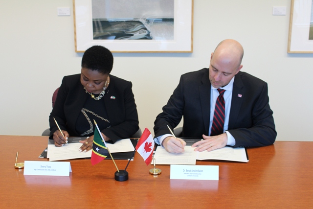 (l-r) Her Excellency Ms. Sherry Tross St. Kitts and Nevis High Commissioner to Canada and Dr. Benoit-Antoine Bacon, President and Vice Chancellor of Carleton University, sign a Memorandum of Understanding in Ottowa, Canada on November 01, 2018
