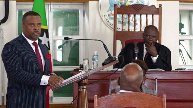 Hon. Mark Brantley, Premier of Nevis and Minister of Finance on Nevis, makes his presentation at the Nevis Island Assembly sitting to Hon. Farrel Smithen President of the Nevis Island Assembly on November 15, 2018, while Ms. Myra Williams, Clerk of the Assembly looks on