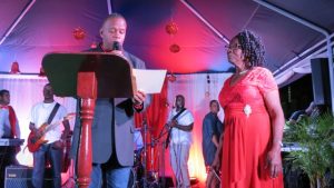 Hon. Eric Evelyn, Minister of Social Development, presenting a certificate of appreciation to Mrs. Zaiditor Olive Jeffers of Craddock Road at the annual Christmas Tree Lighting Ceremony in Charlestown on December 05, 2018