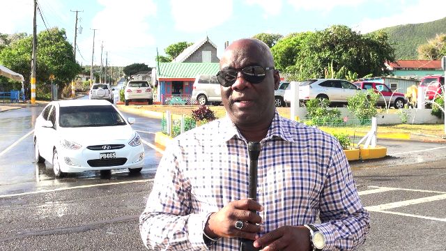 Hon. Alexis Jeffers Deputy Premier of Nevis and Area Representative for the St. James Parish standing at the entrance of Shaws Road in Newcastle on December 19, 2018