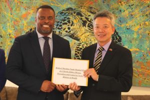 His Excellency Tom Lee, Resident Ambassador of the Republic of China (Taiwan) to St. Kitts and Nevis (right), hands over a cheque to Hon. Mark Brantley, Premier of Nevis and Minister of Health, at his Pinney’s Estate office on December 04, 2018, for procuring two hemodialysis machines and their water-related systems