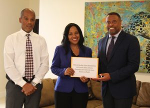 Hon. Mark Brantley, Premier of Nevis and Minister of Health hands over cheque from the government and people of the Republic of China (Taiwan) at his Pinney’s Estate office on December 04, 2018, for the procurement of two hemodialysis machines and their water-related systems to Mrs. Nicole Slack-Liburd, Permanent Secretary in the Ministry of Health while Mr. Gary Pemberton, Administrator at the Alexandra Hospital looks on