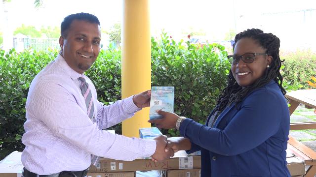 (L-r) Dr. Ravi Chinnaswamy, of the Nevis Dental Clinic hands gifts to Ms. Shinnelle Mills, Assistant Hospital Administrator on January 23, 2019, for use at the Flamboyant Nursing Home