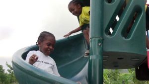 Students of Naomi’s Nursery and Pre School in Garricks Pasture, Jessups Village enjoying a playground donated by the Four Seasons Resort, Nevis