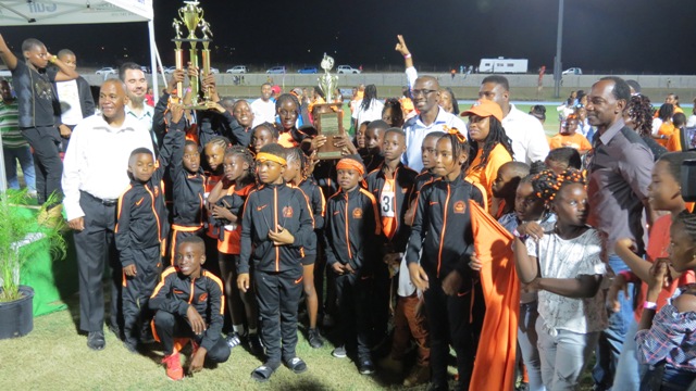 Athletes and staff of the Charlestown Primary School, champions of Zone A in the 27th annual Gulf Insurance Inter-Primary Schools Championship with their trophy presented by Mr. Henry Francis Human Resource Manager of the Gulf Insurance Ltd. in Trinidad, at the Nevis Athletic Stadium at Low Ground on April 03, 2019. Also present are Hon. Eric Evelyn, Minister of Youth and Sports on Nevis and Hon. Troy Liburd, Junior Minister of Education and Mr. Kevin Barrett, Permanent Secretary in the Ministry of Education and Principal Ms. Latoya Jeffers