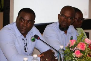 Staff from Surrey Paving & Aggregate Co. Ltd. headed by (l-r) Mr. Desmond Lewis, Deputy Project Director with Mr. Michael Morrison, Project Manager at the head table during a town hall meeting at the Cotton Ground Community Centre on May 30, 2019 held by the Ministry of Communications and Works to appraise residents on Phase 1 of the Island Main Road Rehabilitation and Safety Improvement Project from Cotton Ground to Cliff Dwellers