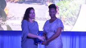 Mrs. Pamela Martin, Resort Manager of the Nisbet Plantation Beach Club, receives the award for Hotel of the Year 2019 on behalf of the resort from First Lady Mrs. Sharon Brantley at the Ministry of Tourism’ s Nevis Tourism Industry Awards ceremony on May 25, 2019, on the grounds of Government House at Bath Plain
