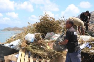 Some officers of the Nevis Task Force preparing to burn more than EC$1million worth of illegal drugs in an operation at the Nevis Solid Waste Management Authority landfill at Long Point on June 13, 2019