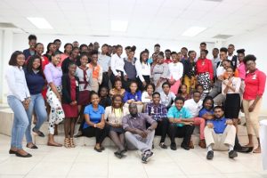 Participants of the Department of Youth 5-week Summer Job Attachment Programme at the St. Paul’s Anglican Church Hall in Charlestown, share a light moment with the department’s staff at the end of the lecture session