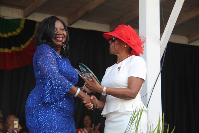 Deputy Governor General of Nevis Her Honour Hyleeta Liburd presents an award to Ms. Ermine Jeffers, one of 10 awardees honoured by the Nevis Island Administration for their sterling contribution to the development of Nevis on the occasion of the 36th Anniversary of Independence of St. Kitts and Nevis at the Independence Day Ceremonial Parade and Awards Ceremony at the Elquemedo. T. Willett Park on September 19, 2019