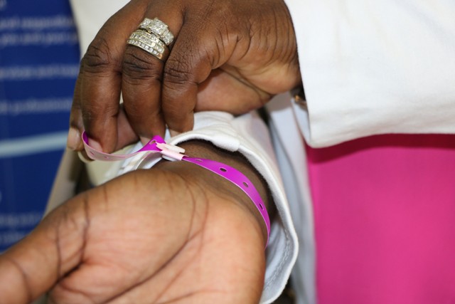 Hon. Hazel Brandy Williams Junior Minister of Health in the Nevis Island Administration demonstrates the use of the new identification wrist bands issued to persons admitted to the Alexandra Hospital during her visit to the health facility on October 11, 2019