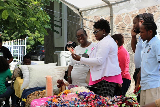 Hon. Hazel Brandy-Williams viewing exhibits at an exhibition staged by the Mental Health Unit in the Ministry of Health on October 11, 2019, at the Nevis Island Administration grounds in Charlestown, with Nurse Joyah Walters, Nurse Manager at the Mental Health Unit on Nevis and other staff members looking on