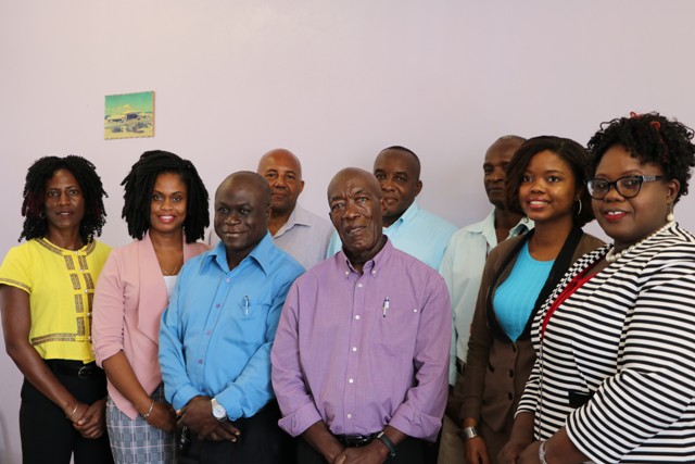 Hon. Hazel Brandy, Junior Minister of Health (front row extreme right) with members of the new Board of Directors at the Nevis Solid Waste Management Authority at the installation ceremony on October 14, 2019, at the Ministry of Communication’s conference room at the Nevis Island Administration’s office in Charlestown. Front row (l-r): Mrs. Shelisa Martin-Clarke, Acting Permanent Secretary in the Ministry of Health and Gender Affairs; Ms. Latoya Jeffers, Ministry of Education; Mr. Andrew Hendrickson, Manager of the Nevis Solid Waste Management Authority; Mr. St. Clair Wallace as the Chairman of the Board; Mrs. Kimberly Hanley-Bello of the Legal Department. (Back row l-r) Mr. Rudy Browne Operations Manager at the Nevis Solid Waste Management Authority; Mr. Oscar Browne, Community Activist; Mr. Anthony Webbe formerly of the Department of Environmental Health. Absent is Ms. Camille Kelly, Architect