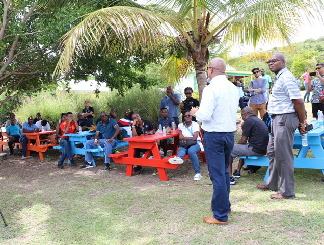 Hon. Spencer Brand, Minister of Water Services on Nevis, welcoming some delegates of the Caribbean Water and Wastewater Association conference in St. Kitts at the Nevisian Heritage Village, during a tour on October 18, 2019. He was accompanied by Dr. Ernie Stapleton, Permanent Secretary in the Ministry responsible for Water Services in the Nevis Island Administration