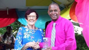 Thelma “TC” Claxton receives her token of appreciation from Hon. Eric Evelyn, Minister of Social Development on behalf of the Department Department of Social Services, Senior Citizens Division, of for their contribution to the development of Nevis at an event dubbed “Afternoon of the lawn” on the grounds of Government house at Bath Plain on October 31, 2019