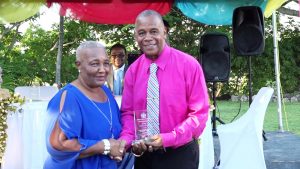 Uretha Flanders receives her token of appreciation from Hon. Eric Evelyn, Minister of Social Development on behalf of the Department Department of Social Services, Senior Citizens Division, of for their contribution to the development of Nevis at an event dubbed “Afternoon of the lawn” on the grounds of Government house at Bath Plain on October 31, 2019