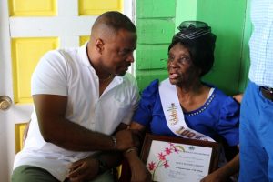 Hon. Mark Brantley, Premier of Nevis presenting a Certificate of Recognition on behalf of the Ministry of Social Development during her 100th birthday celebration at her home in Hamilton on November 30, 2019