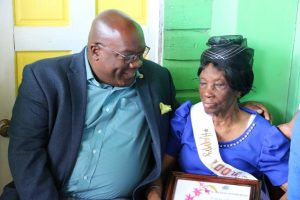 Photo caption: Hon. Dr. Timothy Harris Prime Minister of St. Kitts and Nevis sharing a light moment with Nevis’ newest centenarian Ms. Eliza “Liza Liburd Jeffers” Flanders during her birthday celebration at her home in Hamilton on November 30, 2019