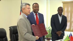 (L-r) His Excellency Tom Lee, Republic of China (Taiwan)’s Resident Ambassador to St. Kitts and Nevis, and Hon. Mark Brantley, Premier of Nevis, showing off copies of the agreement for the Loan Agreement between the Nevis Island Administration and Taiwan International Cooperation and Development Fund in relation to Nevis Small Enterprise Re-lending Project, moments after signing the agreement at Government Headquarters at Pinney’s Estate on December 30, 2019. Mr. Colin Dore, Permanent Secretary in the Ministry of Finance looks on