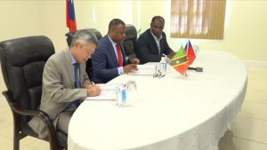 (L-r) His Excellency Tom Lee, Republic of China (Taiwan)’s Resident Ambassador to St. Kitts and Nevis, and Hon. Mark Brantley, Premier of Nevis, signing the Loan Agreement, at Government Headquarters at Pinney’s Estate on December 30, 2019, between the Nevis Island Administration and Taiwan International Cooperation and Development Fund in relation to Nevis Small Enterprise Re-lending Project, while Mr. Colin Dore, Permanent Secretary in the Ministry of Finance looks on