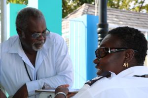 Mr. Ken Pemberton, Nevis Air and Sea Ports Authority’s Operations Manager at the Charlestown Port, having a word with Port Officer Sergeant Berlyn Webbe at the Charlestown Port on December 16, 2019