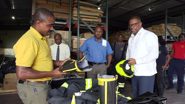 (Extreme left) Mr. Garfield Hodge, Officer in Charge of the St. Kitts and Nevis Fire and Rescue Services, Nevis Department; and Hon Mark Brantley, Premier of Nevis (extreme right) inspecting a number of protective fire suits at the Nevis Disaster Management Department’s warehouse at Long Point on January 16, 2020, while (middle l-r) Mr. Wakely Daniel, Permanent Secretary in the Premier’s Ministry; and Mr. Brian Dyer, Director of the Nevis Disaster Management Unit along with officers of the Nevis Fire and Rescue Services, Nevis Department look on