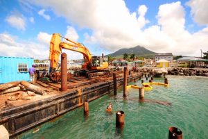 Workers from St. Kitts Marine Works replacing piles for the refurbished tender pier at the Charlestown Port on January 08, 2020
