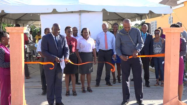 (l-r) Hon. Alexis Jeffers Minister of Lands and Housing in the Nevis Island Administration and Chairman of the Nevis Housing and Land Development Corporation and Mr. Keith Scarborough, Concerned Citizens Movement (CCM) Representative for the St. Thomas’ Parish cut the ribbon to signal the official commissioning of the Colquhoun Manor Road constructed by the Nevis Housing and Land Development Corporation in Phase 2 at the Colquhoun Housing Development in Colquhoun Estate on February 13, 2020