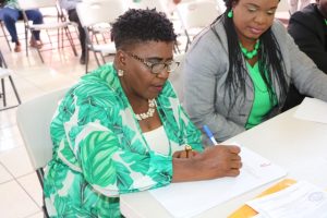 Ms. Jenet Jennifer Jeffers of Cotton Ground signs the Statutory Declaration of a Person Nominating a Candidate for Election as a Member of the Nevis Island Assembly on Nomination Day, February 25, 2020, for Mrs. Cleone Stapleton Simmonds of Cotton Ground (r) the representative for the Nevis Reformation Party, in the March 05, 2020, by-election in District 5, St. Thomas’ Parish (Lowlands)