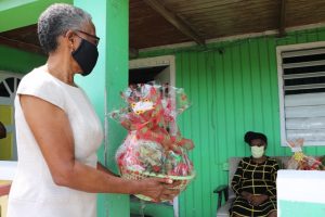 Photo caption: Her Honour Mrs. Hyleeta Liburd, Deputy Governor General on Nevis presenting a fruit basket to 100 year-old Eliza Jeffers of Hamilton on behalf of His Excellency Sir Tapley Seaton, Governor General of St. Kitts and Nevis and the people of the Federation in observance of Centenarians Day celebrated on May 31, 2020