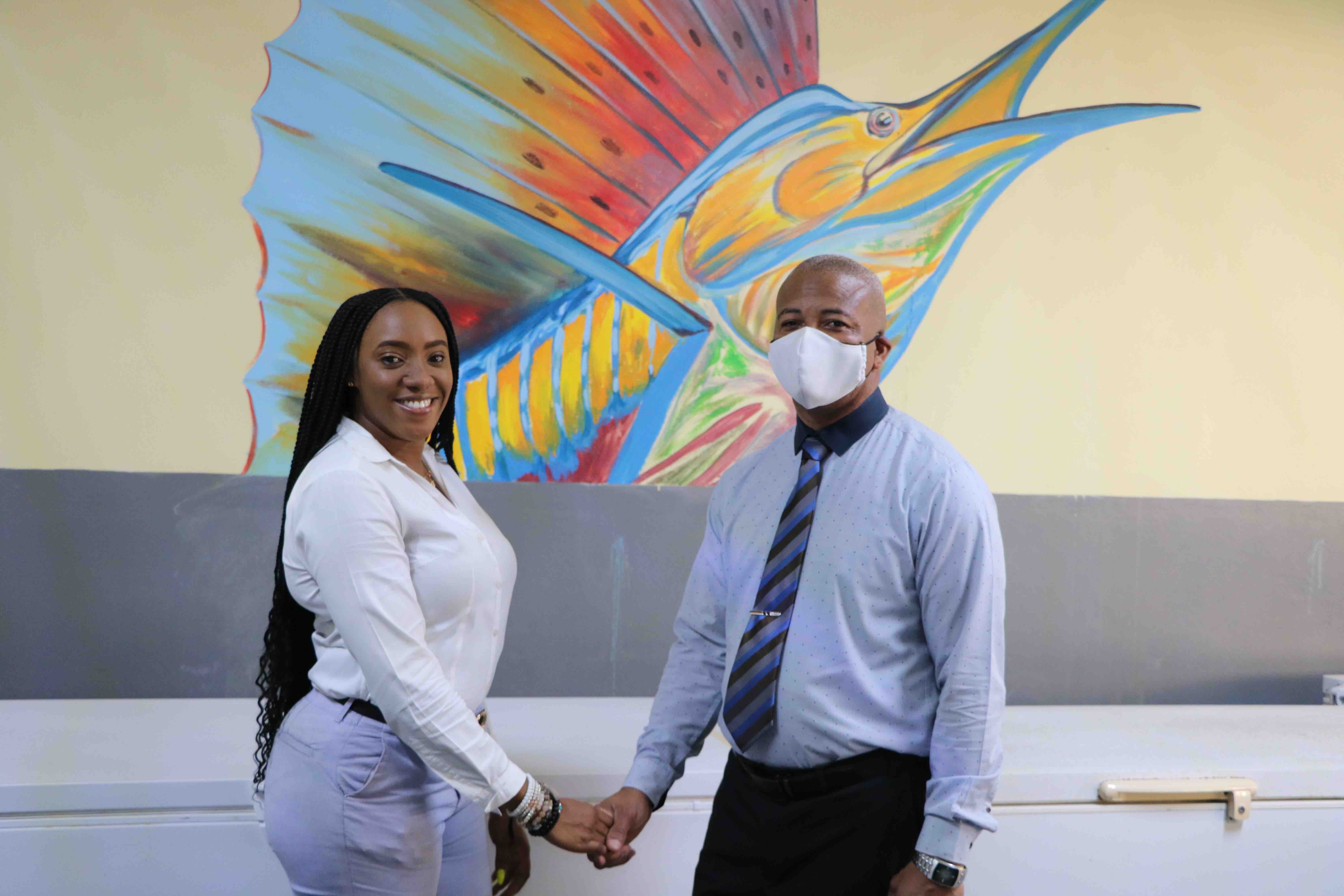 L-r) Ms. Melissa Allen, Manager of Nevis Fishermen's Marketing and Supply Cooperative Society Limited, welcomes Hon. Spencer Brand, Minister of Communication and Works during a visit to the newly refurbished fisheries facility on June 17, 2020