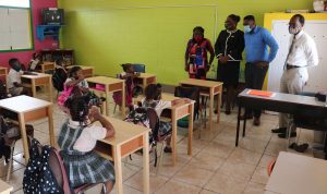 (l-r) A teacher at the Charlestown Primary School with Ms. Zahnela Claxton, Principal Education Officer in the Department of Education; Hon. Troy Liburd, Junior Minister of Education in the Nevis Island Administration, and Mr. Kevin Barrett, Permanent Secretary in the Ministry of Education interacting with students on the first day of the 2020/2021 academic school year on September 07, 2020