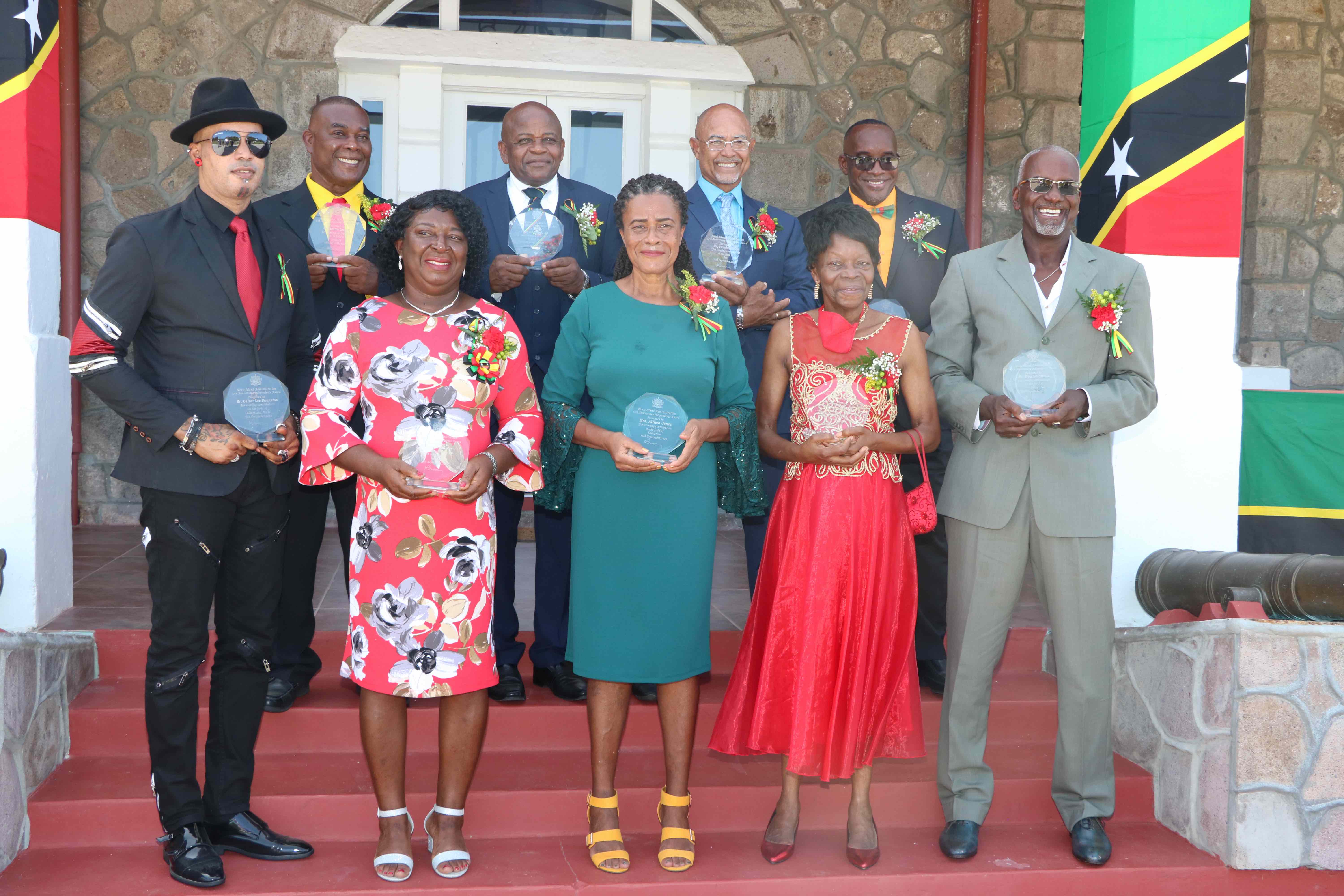 Nine of the 10 awardees showing off their awards on the steps of the picturesque Government House at Belle Vue, moments after they received their Independence Day Awards from Her Honour Mrs. Hyleeta Liburd, Deputy Governor General on Nevis on September 19, 2020. Back row: (l-r) Mr. Austin Lescott; Captain James Greene; Mr. Vaughn Anslyn; and Mr. Oscar “Astro” Browne. Front row: (l-r) Mr. Calver Lee “Gharlic” Swanston; Ms. Laurel Smithen; Mrs. Althea E. Jones; Ms. Thelma E. Hunkins; and Mr. Winston Crooke