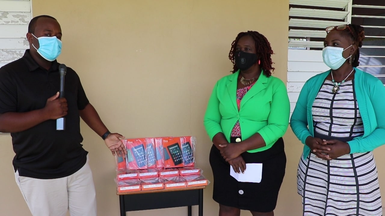 (l-r) Irvine Pinney Jr. representing local business RG Solomon & Sons Ltd. presents 14 Amazon Fire 7 tablets to Mrs. Terres Dore, Education Officer with the Department of Education responsible for the Cecele Browne Integrated School and Mrs. Violet Clarke, Head Teacher of the Cecele Browne Integrated School on October 09, 2020