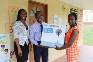 Mr. Kevin Barrett (middle), Permanent Secretary in the Ministry of Education on Nevis handing over a gift of school supplies and equipment from Ms. Latoya Jones (extreme left) to Supervisor of the Inez France Pre School Ms. Monecia Clarke (right) on September 30, 2020