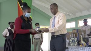 (l-r) Ms. Latoya Jeffers, Education Officer responsible for the Gingerland Secondary School accepts donation from Hon. Eric Evelyn, Minister of Youth and Community Development in the Nevis Island Administration, and area representative for St. George’s, Gingerland on October 09, 2020