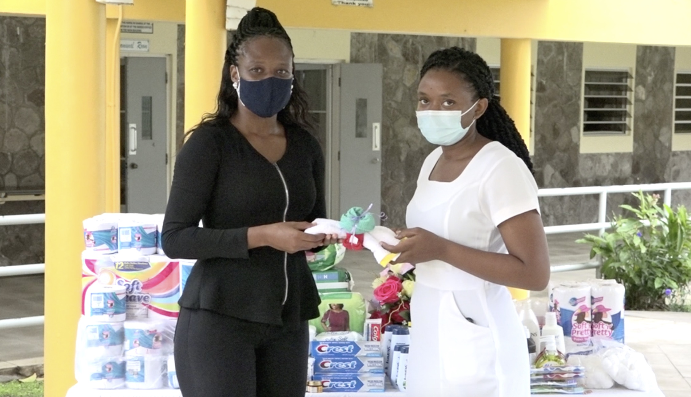 (l-r) Ms. Latoya Jones, President of the Concerned Citizens Movement Women’s Arm presents a donation of essential personal care supplies on behalf of the group to Kella Didier, Registered Nurse for the residents of the Flamboyant Nursing Home on November 10, 2010