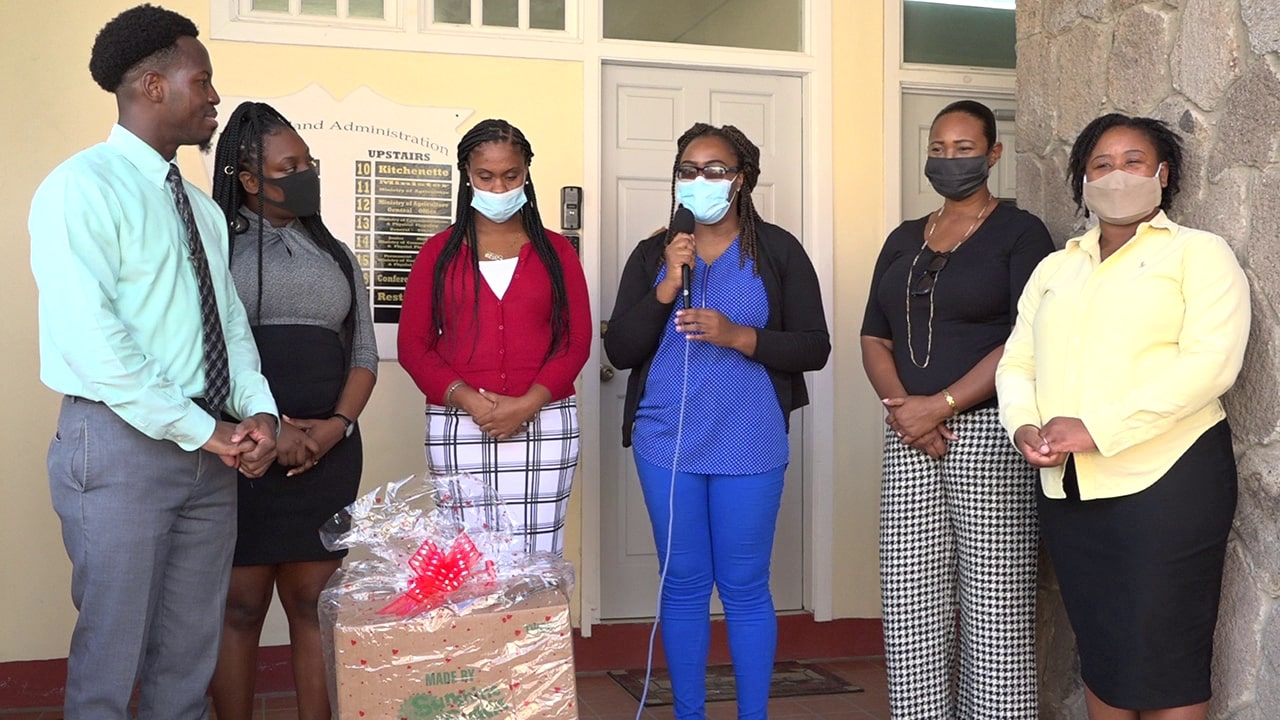 (L-r) Mr. Mario Phillip, Gender Affairs Officer at the department of Gender Affairs; Ms. Jeriella Liburd, Administrative Assistant at the Department of Gender Affairs; Ms. Latoya Jeffers, Assistant Permanent Secretary in the Ministry of Health and Gender accepting a donation of groceries for its Christmas Food Drive from Ms. Shelisa Glasford, Mrs. Pamela Martin and Ms. Lencia Percival on December 21, 2020