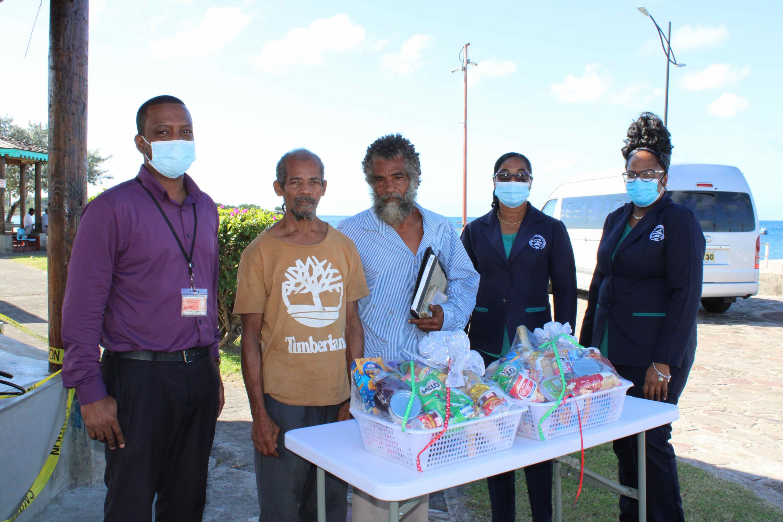 (L-R) Mr. Kenny Warner, Operations Supervisor at the Charlestown Sea Port; Mr. Raoul Archibald; and Mr. Donald Browne, two of the four sanitation workers from the Ministry of Health, honoured by the Nevis Air and Sea Ports Authority, Ms. Loretta France, Human Resource Manager; and Ms. Michelle Lawrence, Administrative Officer, at an appreciation ceremony at the Charlestown Sea Port on Monday 21, December 2020