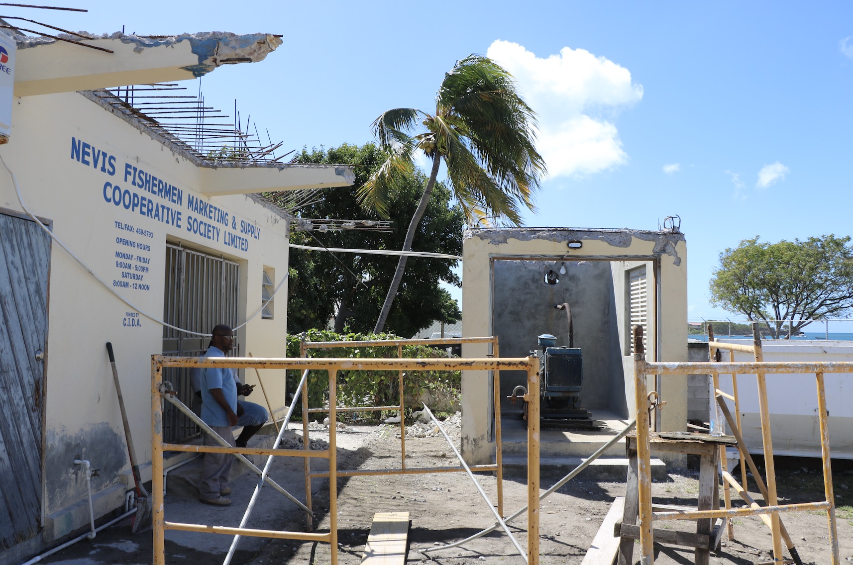 A section of the concrete hangover at the back of the Fisheries Complex in Charlestown along with the concrete roof of the generator room (structure on the right) under repair by the Public Works Department on February 11, 2021