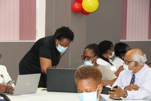 Dr. Judy Nisbett, Chair of the Nevis COVID-19 Task Force (standing) guiding another section of health professionals on Nevis at a World Health Organization training session at the Nevis Disaster Management Department on February 19, 2021, in preparation for administering the AstraZeneca-Oxford vaccine in the fight against COVID-19