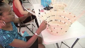 A participant at the at the Department of Gender Affairs’ three-week Basket Weaving Workshop for women weaving a basket at the Pond Hill Community Centre on April 22, 2021