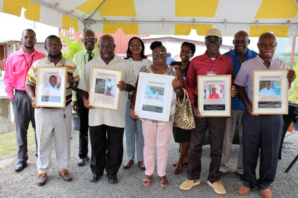 Front row (l-r) Retirees from the Nevis Air & Sea Ports Authority at a ceremony to honour them at Long Point on March 31, 2021 - Mr. Leon Barry; Mr. Anthony Brown; Mrs. Noren Roland; Mr. Rupert Warner; and Mr. Leroy Kelly with officials from the authority - back row (l-r) Mr. Kenyata Warner, Operations Manager at the Charlestown Sea Port; Mr. Oral Brandy, General Manager of the Nevis Air & Sea Ports Authority; Ms. Loretta France, Human Resource Supervisor; Ms. Joanne Flemming, Director of the Nevis Air & Sea Ports Authority Board; and Mr. Joseph Liburd, Chairman of the Board