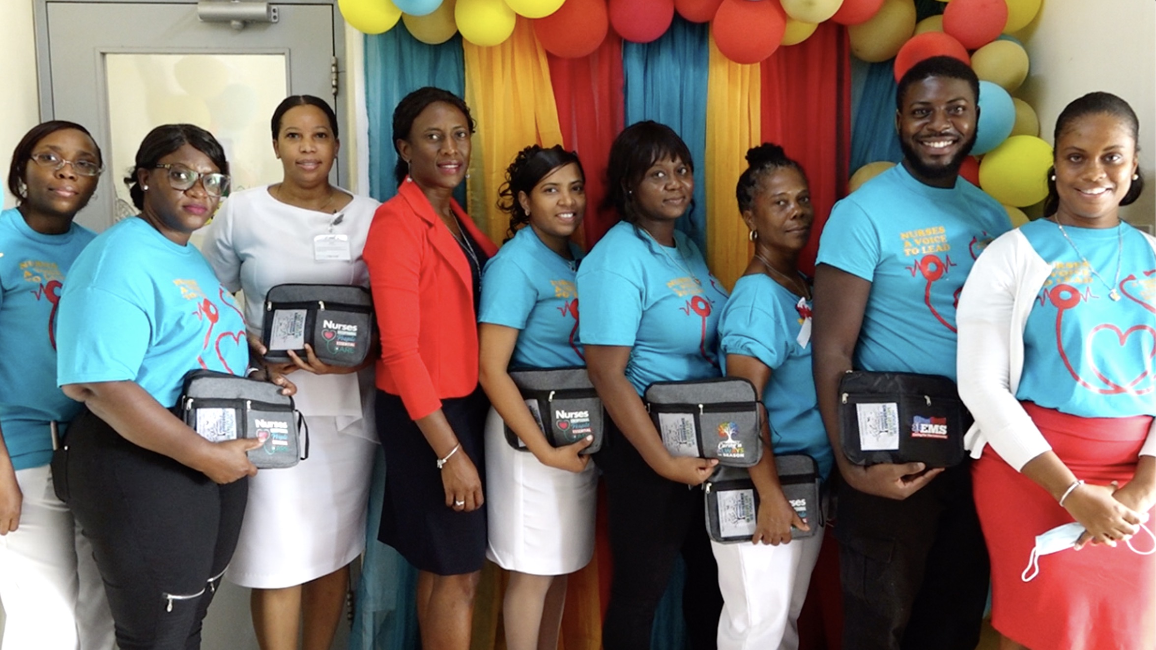 (L-r) Assistant Matron Gracelyn Hanley; Mrs. Simone Harris, President of the Nevis Nurses Association; Assistant Matron Dhaima Golding; Ms. Shelisa Martin-Clarke, Permanent Secretary in the Ministry of Health; Matron Chandreka Persaud-Wallace; Ms. Colleen Hanley, nursing attendant; Ms. Donna Hanley, Nurse Manager at the Flamboyant Nursing Home; Mr. Roan Bramwell, emergency medical technician; and Ms. Latoya Jeffers, Assistant Secretary in the Ministry of Health share a light moment at the Alexandra Hospital on International Nurses Day, May 12, 2021