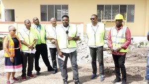 (Forefront) Hon Troy Liburd, Junior Minister of Education on Nevis with Cabinet colleagues (l-r) Mrs.  Hélène Anne Lewis Legal Advisor to the NIA; Hon. Eric Evelyn; Mr. Stedmond Tross, Cabinet Secretary; Hon. Spencer Brand; Hon. Mark Brantley, Premier of Nevis; and Hon. Alexis Jeffers, Deputy Premier of Nevis on site at the Gingerland Secondary School Technical Vocational Education and Training wing on August 12, 2021