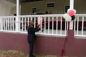 Hon. Eric Evelyn cuts the ribbon to the Yes To Success - Youth Skills Training and Diversion programme’s training centre at Pinney’s Estate in October 2020 (file photo)